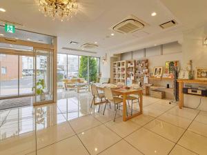 a dining room with a table and chairs in a building at Kumagaya - Hotel - Vacation STAY 88845 in Kumagaya