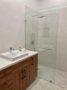 a bathroom with a sink and a shower at Cozy, Comfy and Spacious Apartment in Olón