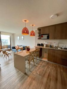 a kitchen and living room with a table and chairs at Excepcional Depto Puerto Varas in Puerto Varas +13 photos