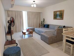 a living room with a couch and a table at Marassi Marina West in El Alamein