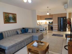 a living room with a couch and a table at Marassi Marina West in El Alamein