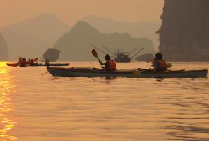a group of people in kayaks on the water at Halong Luxury Cruise in Ha Long