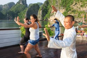 a group of people dancing on a boat at Halong Luxury Cruise in Ha Long