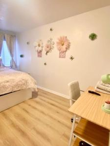a bedroom with a bed with flowers on the wall at Pink Cozy house 2 bedrooms in Rosemead