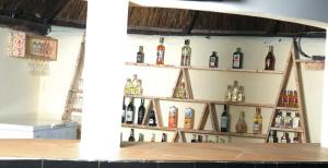 a display of wine bottles on a wall at CHAMBO VILLAS in Morogoro