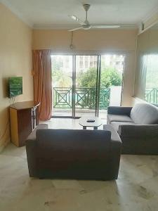 a living room with a couch and a table at Pd Bayu Beach Resort Apartment A2.16 in Port Dickson