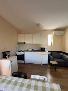 a small kitchen and living room with a couch at Shabla Lux Guest Houses in Shabla