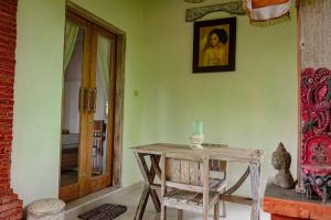 a room with a wooden table and a picture on the wall at Kresna Asih House in Tampaksiring +18 photos