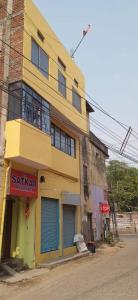 a yellow building on the side of a street at Goroomgo Satkar Residency Varanasi in Varanasi