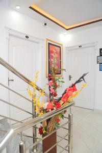 a vase of flowers on a railing in a hallway at Moven Inn Hotel Islamabad in Islamabad