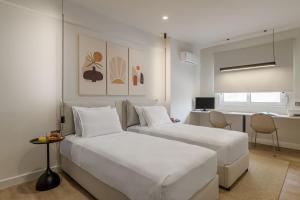 a hotel room with two beds and a desk at Acropolis View Plunge Pool Loft in Athens