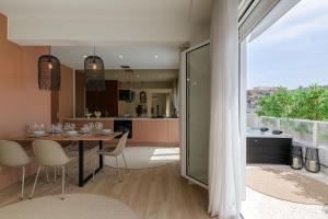 a kitchen and dining room with a table and chairs at Acropolis View Plunge Pool Loft in Athens