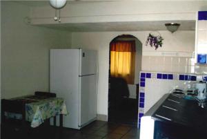 a kitchen with a refrigerator and a table in it at Havasu Inn & Suites in Lake Havasu City