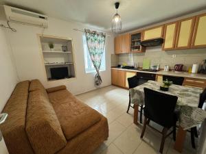 a living room with a couch and a table at Apartmani Luciano in Novalja +26 photos