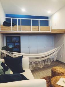 a living room with a couch and a hammock at Sunrise from bed Apartment - NhaTrang Beach in Nha Trang