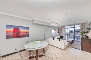 a living room with a couch and a table at The Icon Capetown in Cape Town