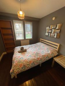 a bedroom with a bed with a stuffed animal on it at 69D Victoria Street in Sheffield