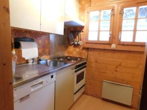 a kitchen with a sink and a stove top oven at Chalet Silentium in Bellwald +14 photos