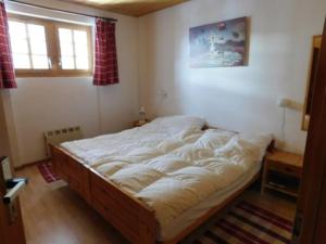 a bedroom with a large bed in a room at Chalet Silentium in Bellwald
