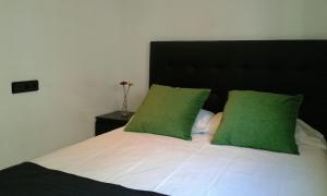 a bedroom with a bed with green pillows at Residencia Mayol - Adults Only in Palma de Mallorca +11 photos