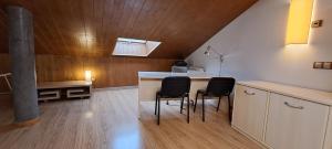 a kitchen with a counter and chairs in a room at Dúplex Luxury Alfaro in Alfaro +36 photos