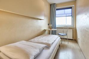 Ένα ή περισσότερα κρεβάτια σε δωμάτιο στο Appartementhaus Schildt, FeWo 4