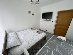 Postel nebo postele na pokoji v ubytování L'étoile de Seine 77 Appartement 3