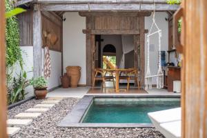 a house with a swimming pool in the yard at Akasia Villas - Private Pool Villas in Gili Islands