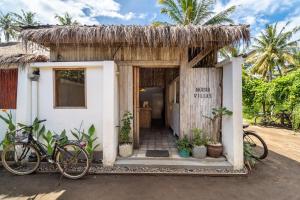 a small house with bikes parked outside of it at Akasia Villas in Gili Air