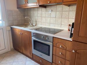 a kitchen with a stove and a sink at Summer Home in Potos