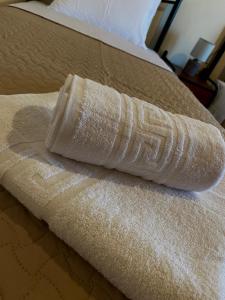 a wrapped up towel sitting on a bed at Summer Home in Potos