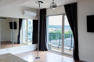 a living room with a large window with a view at Thome Vlaicu170 Jacuzzi in Cluj-Napoca