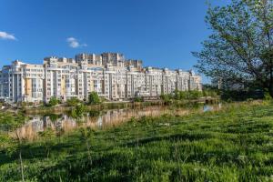 a large white building next to a body of water at StarRent Albisoara in Chişinău