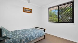a bedroom with a bed and a window at Pet Friendly Beach Bungalow in Woorim +8 photos
