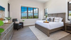 a bedroom with a bed and a chair and windows at BLUE TRANQUILITY Luxurious home in private community with Heated Private Pool Spa Detached Ohana Suite in Waimea