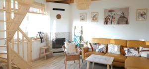 a living room with a couch and a fireplace at Agroturystyka Stara Huta - Domek Boho in Narol