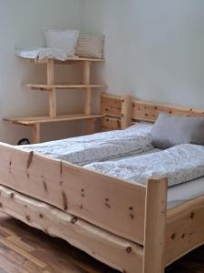 a bed with a wooden frame in a room at Baumgartner - Bauernhaus in Weißkirchen in Steiermark