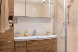 a bathroom with a sink and a shower at Ferienwohnung Haas Maria in Neustift im Stubaital +26 photos
