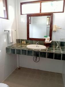a bathroom with a sink and a mirror at Pinnacle Samui Resort in Mae Nam