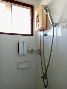 a shower in a bathroom with a shower head at Pinnacle Samui Resort in Mae Nam