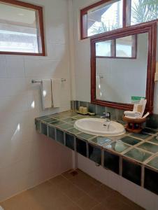 a bathroom with a sink and a mirror at Pinnacle Samui Resort in Mae Nam
