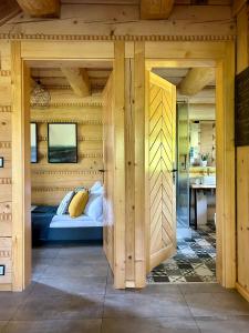 a bedroom with a bed in a wooden room at Dom z drzew in Istebna