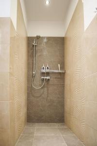 una ducha en un baño con una pared de azulejos en Strzelecka Old Town Apartament, en Gdansk