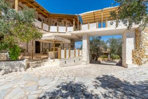 an exterior view of a house with a patio at Paco's Resort Luxury House 16 in Oziás