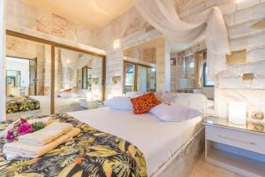 a large bedroom with two beds and a large mirror at Paco's Resort Luxury House 16 in Oziás +26 photos