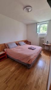 a bedroom with a bed and a wooden floor at Trento, Monte Bondone, casa tipica di montagna in Norge