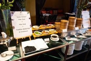 a display case with plates of food on a table at lebua at State Tower in Bangkok