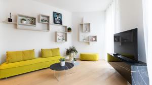 een woonkamer met een gele bank en een tafel bij Aliprandi 29 in Monza