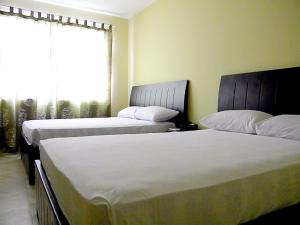 Voodi või voodid majutusasutuse Hotel Marvento II toas