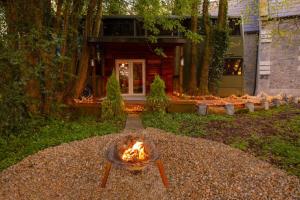 a fire pit in a yard in front of a house at The Bus In The Woods in Belturbet